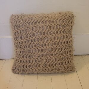 Very soft, fluffy beige colored decorative pillow